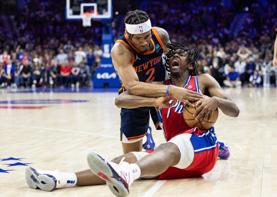 The Sixers' Tyrese Maxey, right, and the Knicks' Miles McBride battle for the ball during the second half of Game 4 on Sunday in Philadelphia.