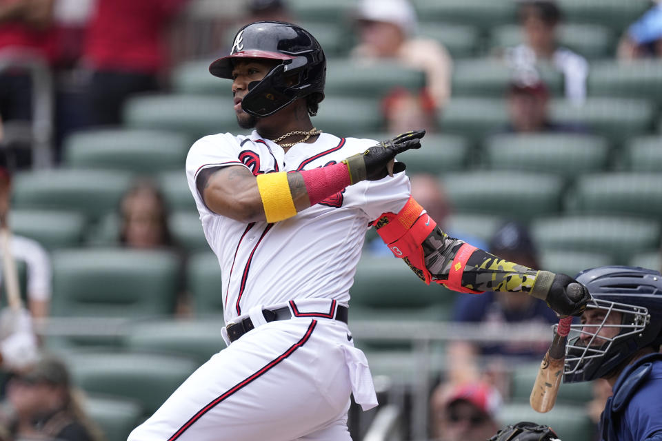 Atlanta Braves' Ronald Acuna Jr. (13) follows through on a single during the first inning of a baseball game against the Seattle Mariners, Sunday, May 21, 2023, in Atlanta. (AP Photo/John Bazemore)