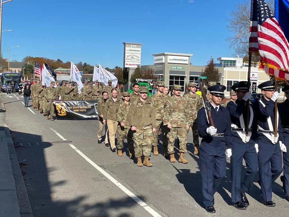 Military units march at the start of the parade at Grove and North streets.