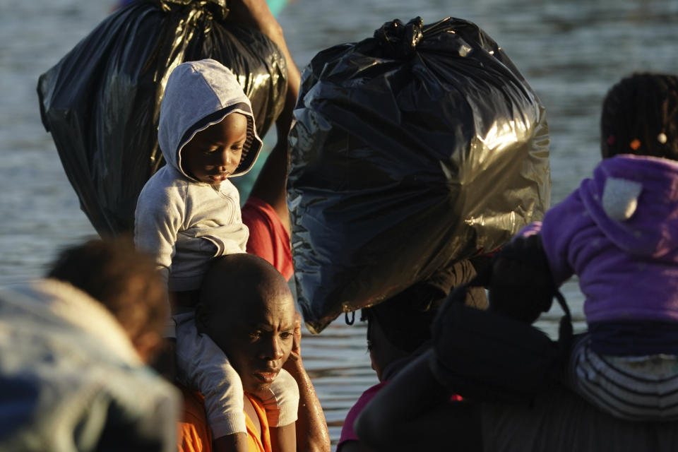 Migrants cross the Rio Grande river to Del Rio, Texas, from Ciudad Acuna, Mexico, early Thursday, Sept. 23, 2021. (AP Photo/Fernando Llano)