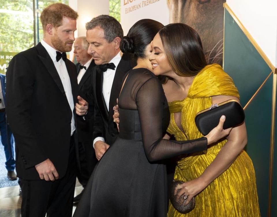 Britain's Prince Harry, Duke of Sussex (L) chats with Disney CEO Robert Iger as Britain's Meghan, Duchess of Sussex (2nd R) embraces US singer-songwriter Beyoncé (R) as they attend the European premiere of the film The Lion King in London on July 14, 2019. | Niklas Halle'n—AFP/Getty Images