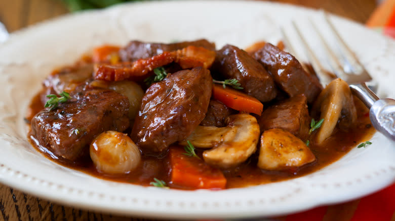 beef bourguignon in white dish