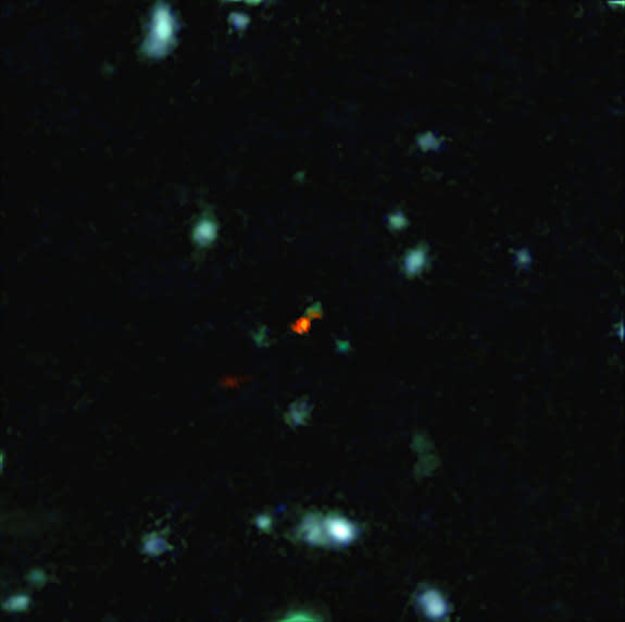 This image, built from the Atacama Large Millimeter/submillimeter Array (ALMA) and the Very Large Telescope, shows an extremely distant galaxy, BDF3299, forming when the universe was less than 800 million years old. The red cloud to the lower l