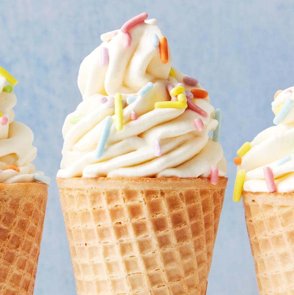 a cone piped with homemade soft serve ice cream topped with sprinkles