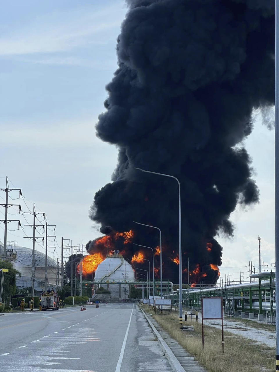 Black smoke billows after an explosion at the gas storage tanks in an industrial area in Rayong province, eastern of Thailand, Thursday, May 9, 2024. At least one person was killed and several others injured after a huge fire broke out at gas storage tanks. (Fire & Rescue Thailand via AP)