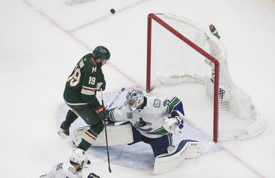 Minnesota Wild's Luke Kunin (19) is stopped by Vancouver Canucks goalie Jacob Markstrom (25) during the second period of an NHL hockey playoff game Thursday, Aug. 6, 2020 in Edmonton, Alberta. (Jason Franson/The Canadian Press via AP)