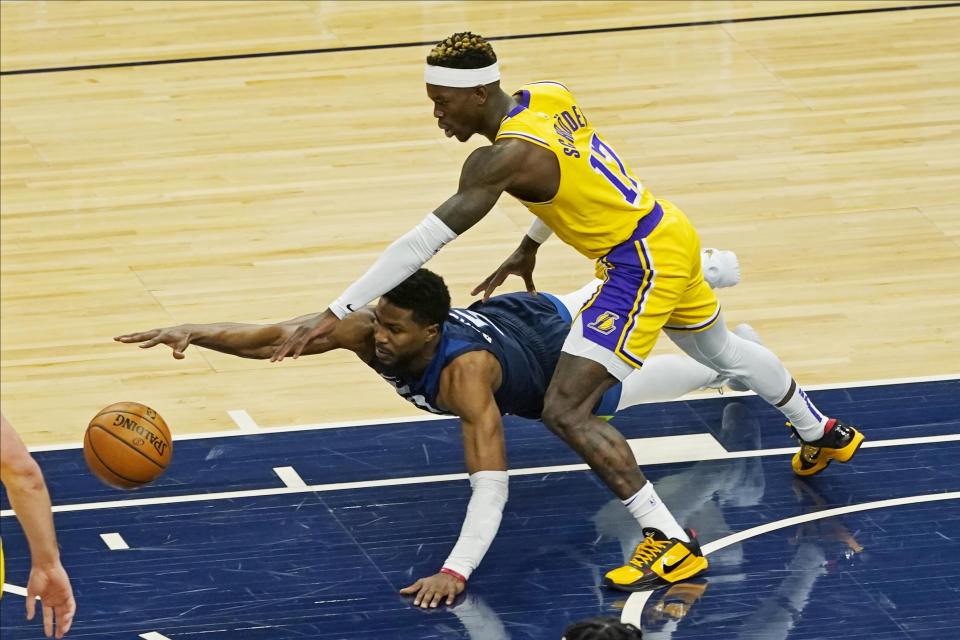 Minnesota Timberwolves' Malik Beasley, left, dives as he and Los Angeles Lakers' Dennis Schroder (17) chase the loose ball in the first half of an NBA basketball game, Tuesday, Feb. 16, 2021, in Minneapolis. (AP Photo/Jim Mone)