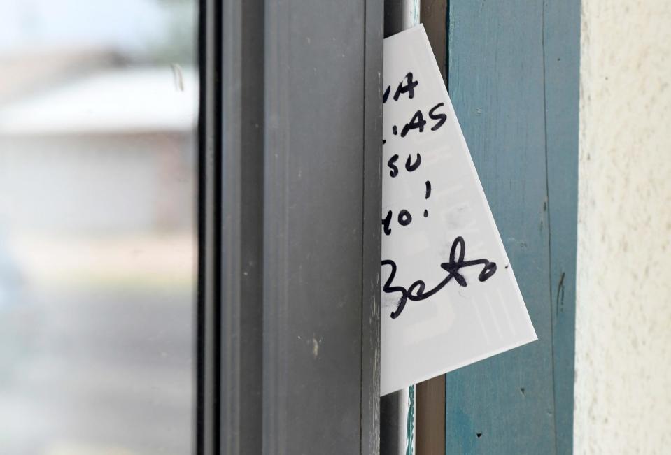 Texas governor candidate Beto O'Rourke leaves a card in a door during his door knocking in a neighborhood in Snyder on Thursday.