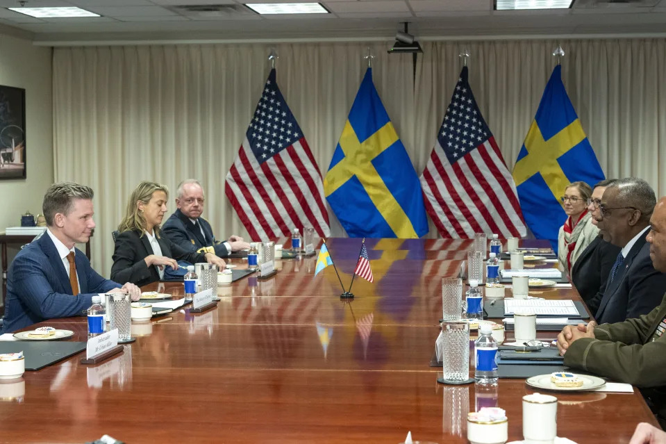 Defense Secretary Lloyd Austin, right, speaks during a meeting with Swedish Defense Minister Pal Jonson, left, at the Pentagon on Tuesday, Dec. 5, 2023, in Washington. (AP Photo/Kevin Wolf)