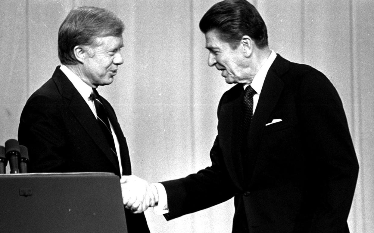 Jimmy Carter (left) and Ronald Reagan at a 1980 television debate - AP