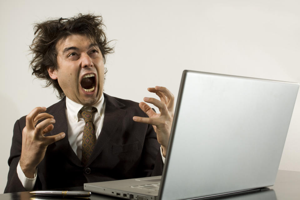 a business man screaming isolated on white. bad news?