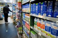 Cartons of milk are displayed on shelves at a supermarket in Beijing