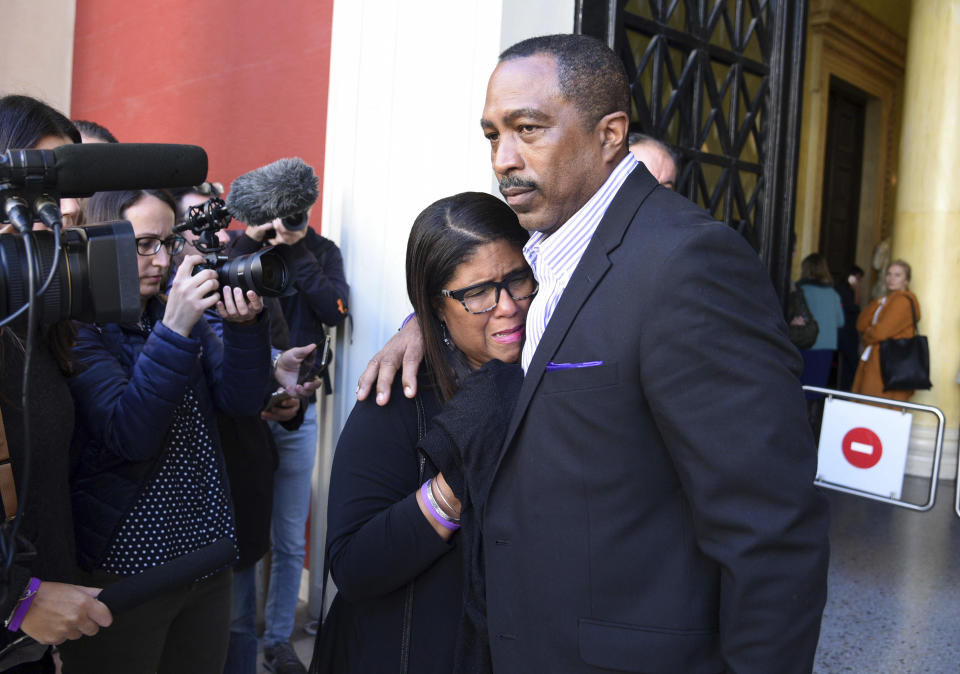 Jill Henderson reacts next to her husband phill outside the court house in Patras, Greece , on Thursday, Nov. 22, 2018. Greek court on Thursday convicted and sentenced six of nine suspects in the fatal beating of an American tourist in an island resort last year, handing down sentences of five to 15 years on reduced charges of deliberate bodily harm. Bakari Henderson, a 22-year-old of Austin, Texas, died after being beaten in the street following an argument in a bar in the popular Laganas resort area of Zakynthos island in July 2017. (AP Photo/Giannis Androutsopoulos)