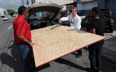 People buy materials as they prepare for Hurricane Irma, in Bayamon - Credit: ALVIN BAEZ/Reuters