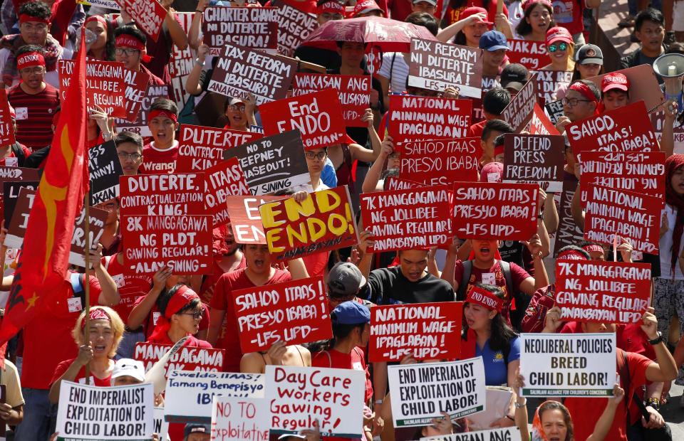 <p>Protesters, mostly workers, march towards the Presidential Palace during the global commemoration of Labor Day, May 1, 2018 in Manila, Philippines. About 5,000 workers and activists from various groups held a rally Tuesday near the Malacanang Palace to protest the failure of Philippine President Rodrigo Duterte to fulfill a major campaign promise to end contractualization, the widespread practice of short-term employment. (Photo: Bullit Marquez/AP) </p>