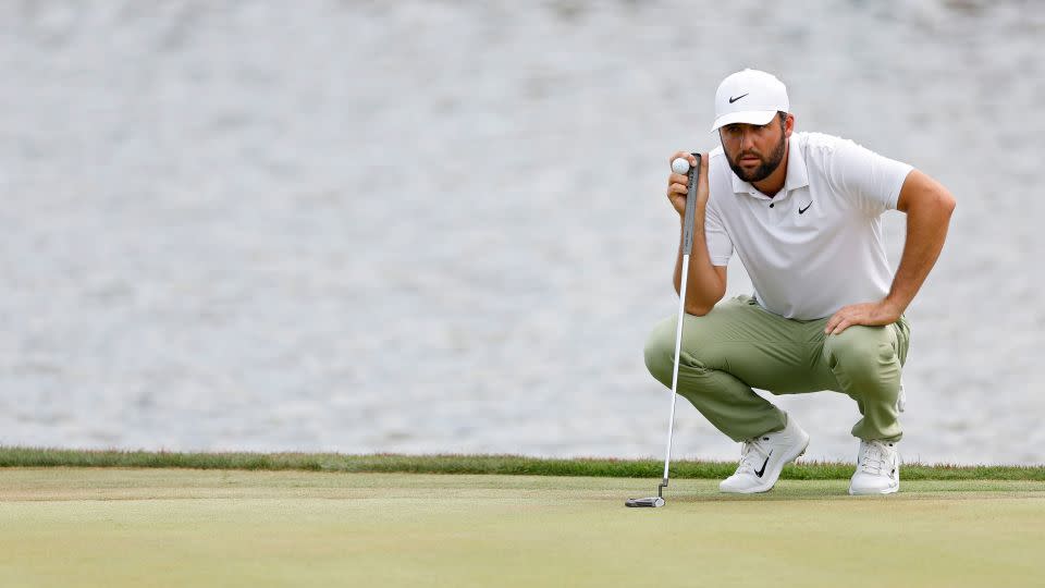 Scheffler lines up a putt on the 18th green during his final round. - Mike Ehrmann/Getty Images