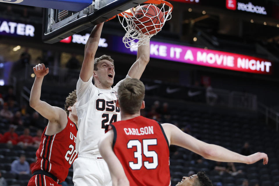 Oregon State's Kylor Kelley (24) dunks against Utah during the first half of an NCAA college basketball game in the first round of the Pac-12 men's tournament Wednesday, March 11, 2020, in Las Vegas. (AP Photo/John Locher)