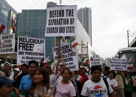 Protesters belonging to the Iglesia ni Cristo (Church of Christ) group display placards as they march along EDSA highway in Mandaluyong, Metro Manila August 30, 2015. REUTERS/Erik De Castro