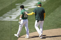 Oakland Athletics' Ramon Laureano is walked off the field after charging the Houston Astros dugout after being hit by a pitch thrown by Humberto Castellanos in the seventh inning of a baseball game Sunday, Aug. 9, 2020, in Oakland, Calif. (AP Photo/Ben Margot)
