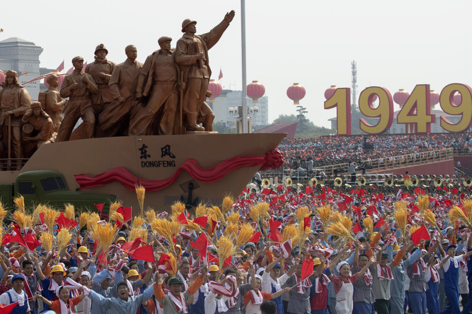 Performers dance at a parade for the 70th anniversary of the founding of the People's Republic of China in Beijing on Tuesday, Oct. 1, 2019. A colorful parade with 70 floats and 100,000 participants highlighting communist China's achievements is following a military parade in Beijing on the 70th anniversary of Communist Party rule. (AP Photo/Ng Han Guan)