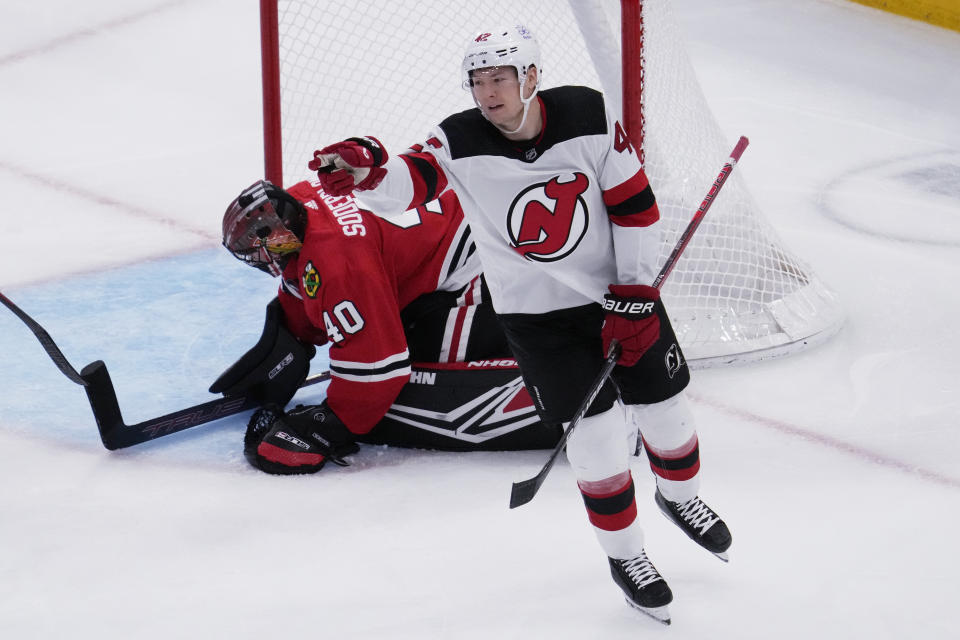New Jersey Devils center Curtis Lazar, right, points after scoring Chicago Blackhawks goaltender Arvid Soderblom, left, looks down during the third period of an NHL hockey game in Chicago, Sunday, Nov. 5, 2023. (AP Photo/Nam Y. Huh)