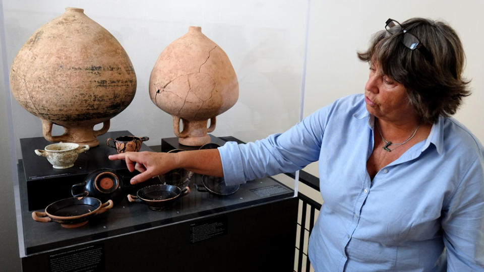 Dutch archeologist Marijke Gnade, researcher in pre-Roman archeology at the University of Amsterdam, shows objects and amphora found in the vineyard of the Casale Del Giglio in the small village of Borgo Le Ferriere near Nettuno, south of Rome, on October 8, 2014. The Santarelli family discovered under his vineyards, Roman remnants of a Sacred Way from the sixth century BC. JC which leads to the acropolis of Satricum, where the temple of Mater Matuta (goddess of the dawn) stands.