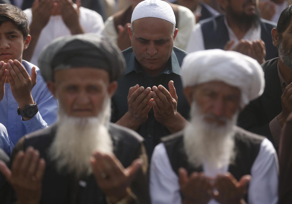Afghan Muslims attend Eid al-Adha prayers in Kabul, Afghanistan, Sunday, Aug. 11, 2019. Muslim people in the country celebrate Eid al-Adha, or the Feast of the Sacrifice by slaughtering sheep, goats and cows whose meat will later be distributed to the poor. (AP Photo/Rafiq Maqbool)