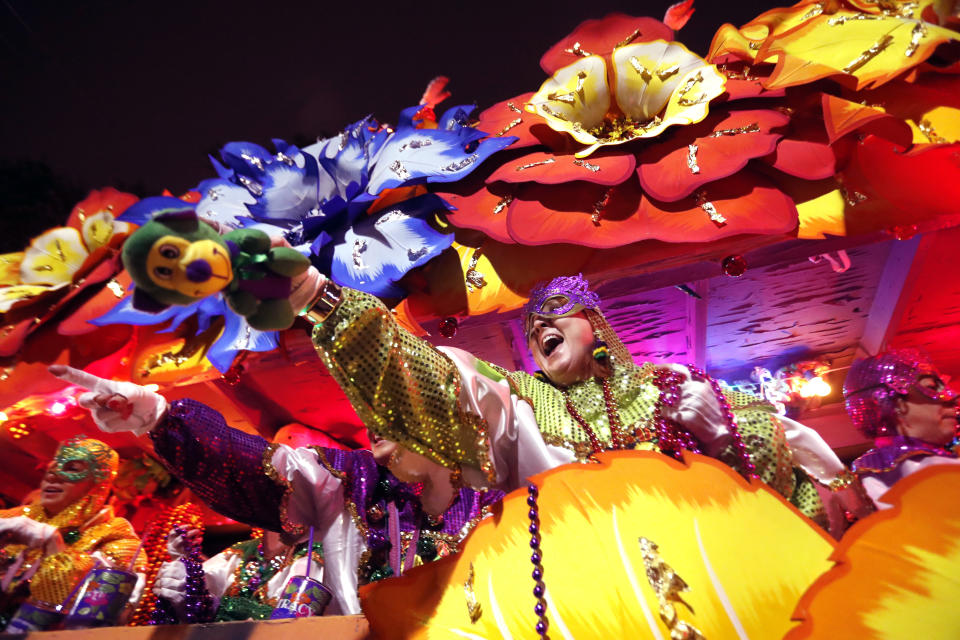 FILE - Mardi Gras Float riders toss trinkets as the Krewe of Orpheus rolls in New Orleans, Monday, Feb. 12, 2018. The countdown to Mardi Gras begins Saturday, Jan. 6, 2024, in New Orleans as Carnival season kicks off with dozens of costumed revelers and a brass band set to crowd onto a streetcar for the Phunny Phorty Phellows' nighttime ride down historic St. Charles Avenue. Meanwhile, a walking club in the French Quarter will march in its annual procession honoring Joan of Arc. (AP Photo/Gerald Herbert, File)