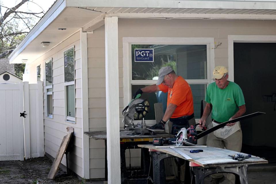 Manatee County Habitat for Humanity volunteers work on cutting flooring for a home in Palmetto that is being remodeled. Tiffany Tompkins/ttompkins@bradenton.com