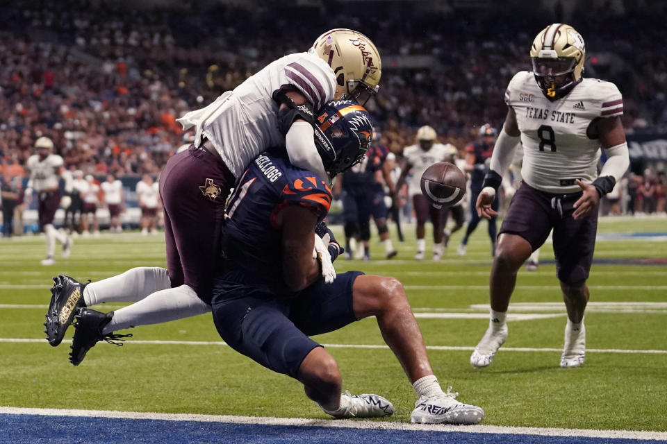 Texas State cornerback Kaleb Ford-Dement, left, breaks up a pass intended for UTSA wide receiver Tykee Ogle-Kellogg, center, during the second half of an NCAA college football game, Saturday, Sept. 9, 2023, in San Antonio. (AP Photo/Eric Gay)