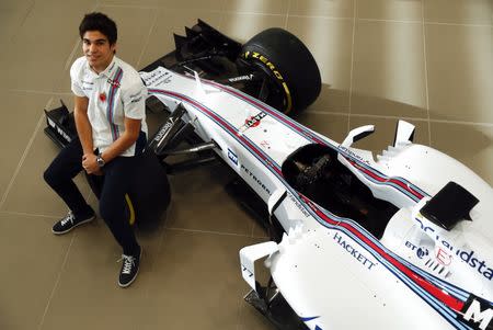 The newly announced Williams Martini Racing driver for the 2017 season Lance Stroll poses for photographers beside this years Formula 1 car at their base in Wantage, Britain November 3, 2016. REUTERS/Eddie Keogh - RTX2RPJA