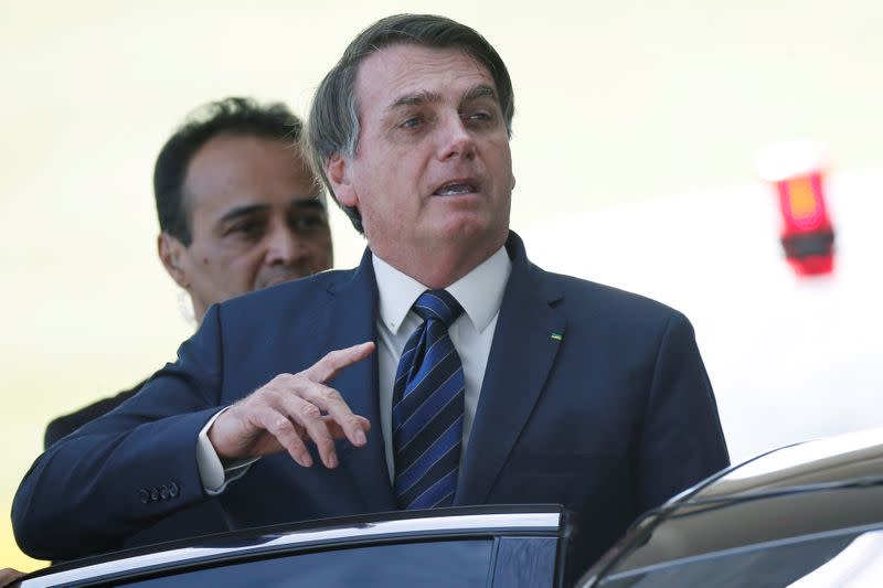 Brazil's President Jair Bolsonaro gestures as he leaves the Alvorada Palace, amid the coronavirus disease (COVID-19) outbreak, in Brasilia