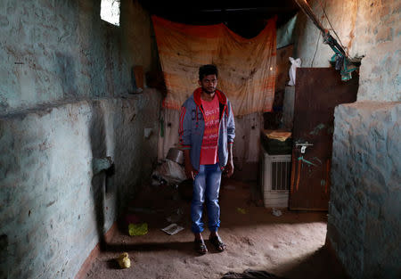 Mohammed Afroz, who survived a mob lynching attack which killed his friend Mohammed Azam, poses inside the room where he hid after the attack in Handhikera village in Bidar, India, July 19, 2018. REUTERS/Danish Siddiqui