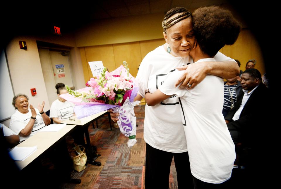 Carolyn Jones gets flowers from her grandson, Conner Haygood, after they finished the table reading of her play, Beauty and the Ballot Box, which depicts Shreveport's civil rights struggle through the eyes of the Modern Beauty Shop, at Shreve Memorial Library Wallet Branch on March 26, 2023. 
