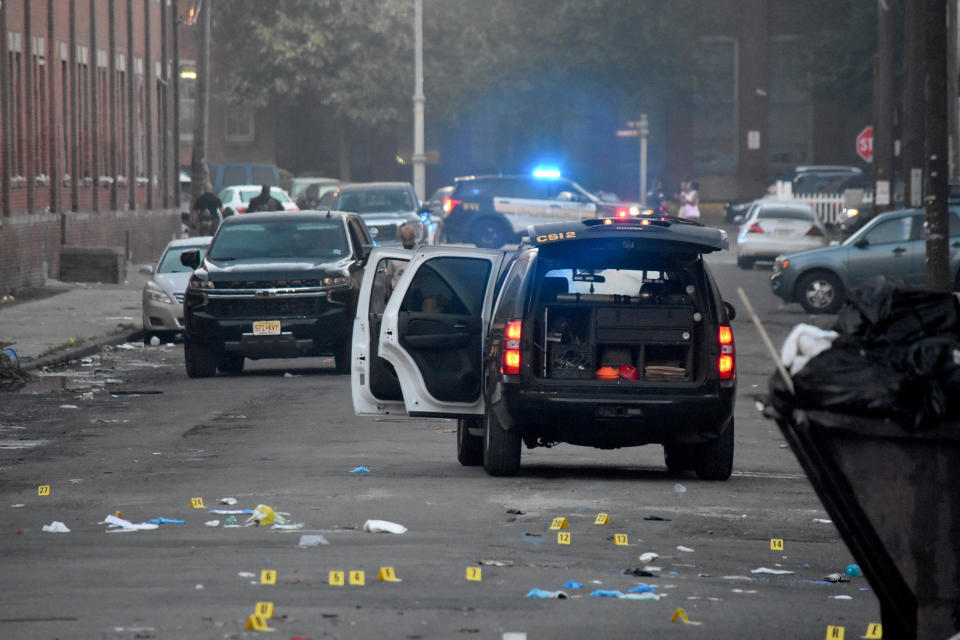 Law enforcement vehicles at the scene of a mass shooting.