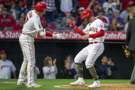 Los Angeles Angels designated hitter Shohei Ohtani, left, congratulates Taylor Ward, right, for scoring on a double by Mike Trout against the Oakland Athletics during the third inning of a baseball game in Anaheim, Calif., Friday, May 20, 2022. (AP Photo/Alex Gallardo)