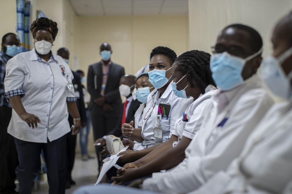 Medical staff wait in line to receive some of the country's first coronavirus vaccinations using AstraZeneca COVID-19 vaccine manufactured by the Serum Institute of India and provided through the global COVAX initiative, at Kenyatta National Hospital in Nairobi, Kenya Friday, March 5, 2021. Urgent calls for COVID-19 vaccine fairness rang through African countries on Friday as more welcomed or rolled out doses from the global COVAX initiative, with officials acutely aware their continent needs much more. (AP Photo/Ben Curtis)