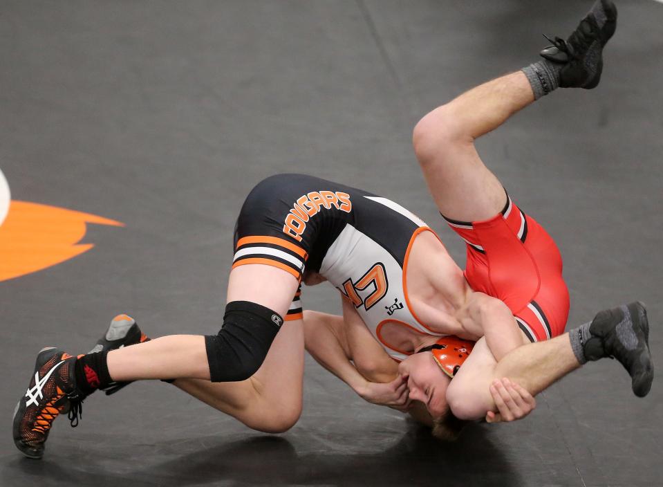 Central Kitsap's Quinn Lawrence wrestles Yelm's Roman Rosenberg in their 126-pound bout on Thursday, Jan. 20, 2022.