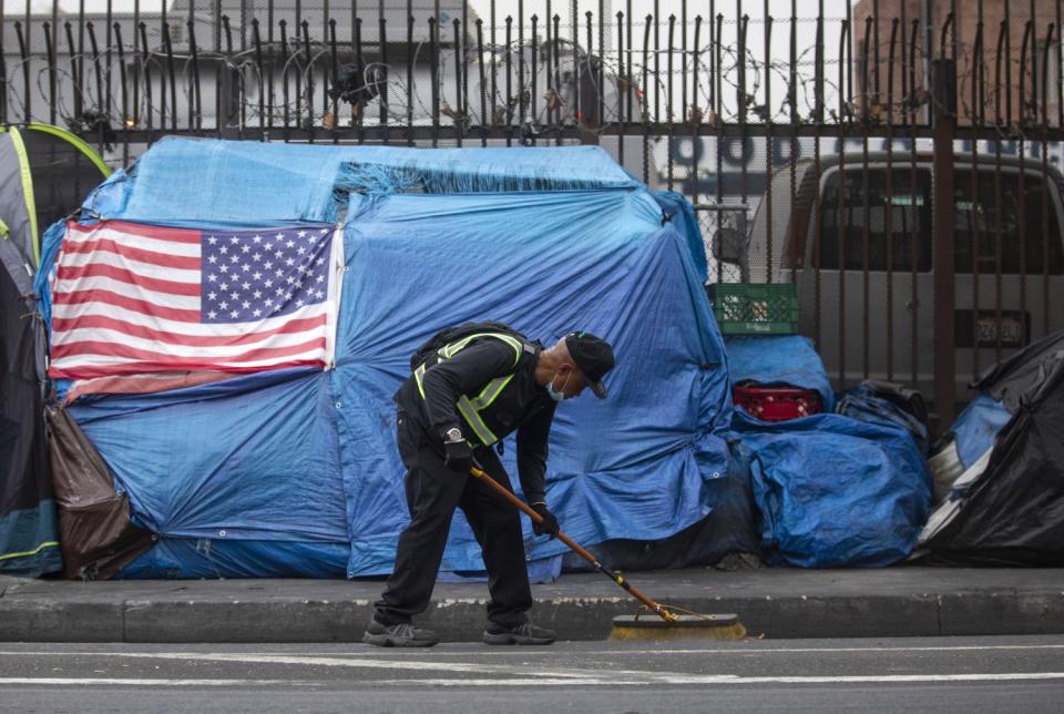 Urban Alchemy practitioner Barney Hines Jr., 56, is cleaning the gutters in skid row in Los Angeles.