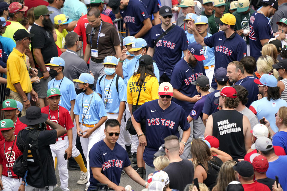 Members of the Boston Red Sox give autographs to fans as they arrive at the Little League World Series tournament in South Williamsport, Pa., Sunday, Aug. 21, 2022. (AP Photo/Tom E. Puskar)