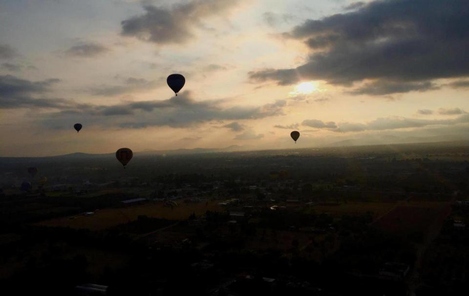 Hot air balloons float towards the city (Susannah Rigg)