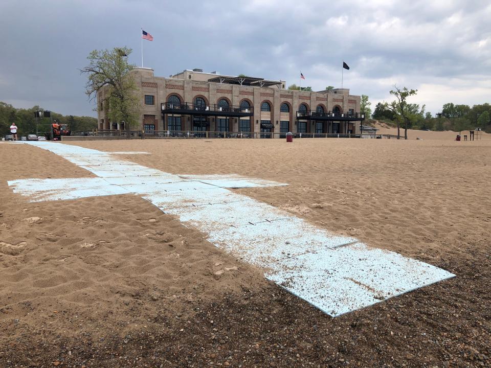 A beach mat at Indiana Dunes State Park makes it possible for wheelchairs to roll between the edge of Lake Michigan, seen here, to the pavilion building.