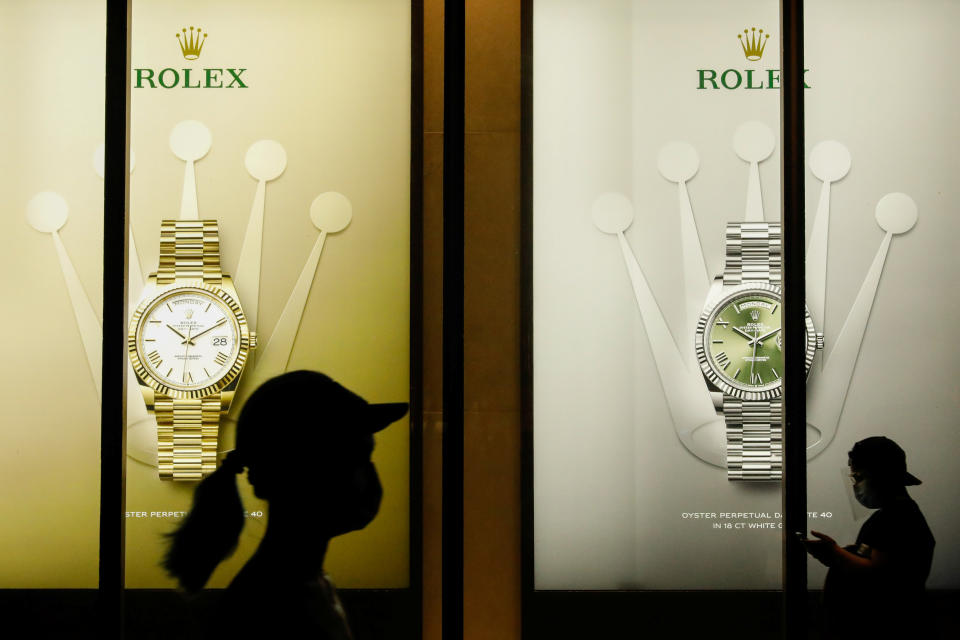 People wearing face masks for protection against the coronavirus disease (COVID-19) walk past a Rolex store at a financial district in Bonifacio Global City, Taguig, Metro Manila, Philippines, September 22, 2020. REUTERS/Eloisa Lopez