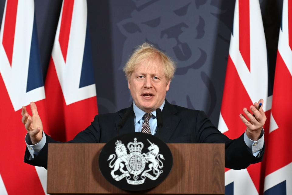 TOPSHOT - Britain's Prime Minister Boris Johnson gestures as he holds a remote press conference to update the nation on the post-Brexit trade agreement, inside 10 Downing Street in central London on December 24, 2020. - Britain said on Thursday, December 24, 2020 an agreement had been secured on the country's future relationship with the European Union, after last-gasp talks just days before a cliff-edge deadline. (Photo by Paul GROVER / POOL / AFP) (Photo by PAUL GROVER/POOL/AFP via Getty Images)