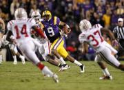 LSU quarterback Jordan Jefferson (9) rushes as Western Kentucky defensive back Kareem Peterson (14) and defensive back Vince Williams (37) converge during the second quarter of their NCAA college football game in Baton Rouge, La., on Saturday, Nov. 12, 2011. (AP Photo/Gerald Herbert)