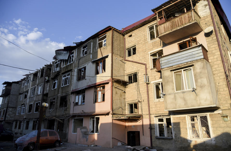 A view of a residential area and cars that were allegedly damaged by shelling during a military conflict in self-proclaimed Republic of Nagorno-Karabakh, Stepanakert, Azerbaijan, Saturday, Oct. 3, 2020. The fighting is the biggest escalation in years in the decades-long dispute over the region, which lies within Azerbaijan but is controlled by local ethnic Armenian forces backed by Armenia. (David Ghahramanyan/NKR InfoCenter PAN Photo via AP)