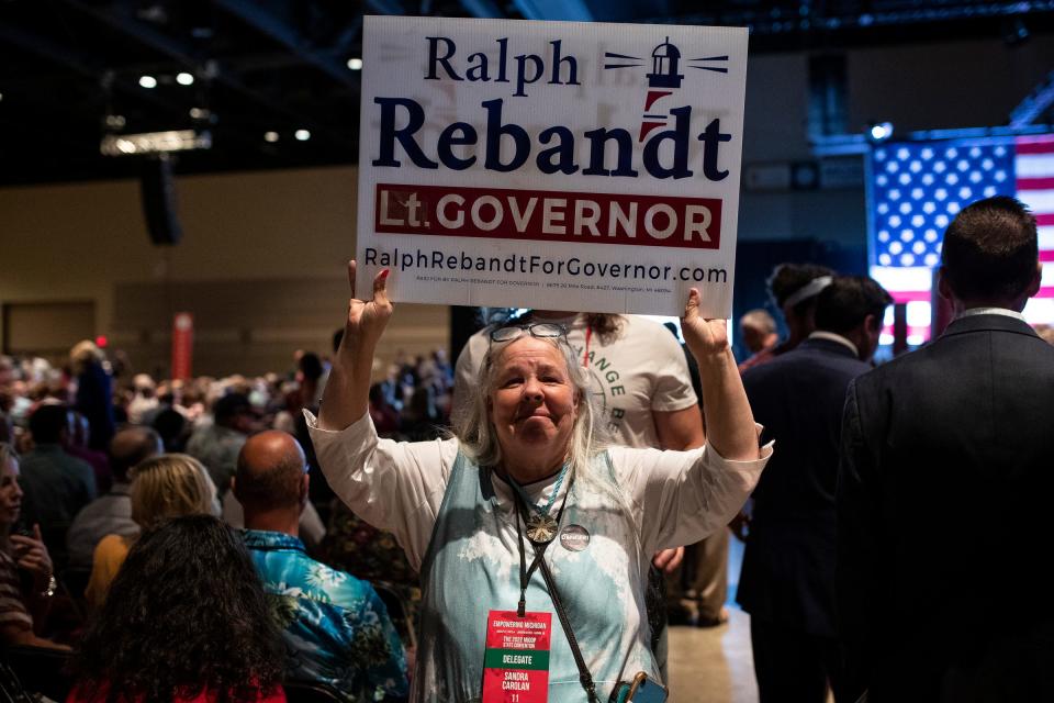 Sandra Carolan, a delegate from the 11th District holds up a Ralph Rebandt for Lt. Gov. Sign during the MIGOP State Nominating Convention at the Lansing Center in Lansing on Saturday, August 27, 2022.