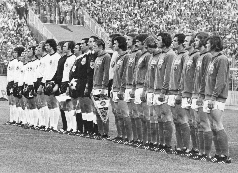 FILE - The teams from West Germany, in white shirts, and East Germany line up for the national anthems before the start of the World Cup Group 1 soccer match in Hamburg, on June 22, 1974. The match ended in a 1-0 win for East Germany. (AP Photo, File)