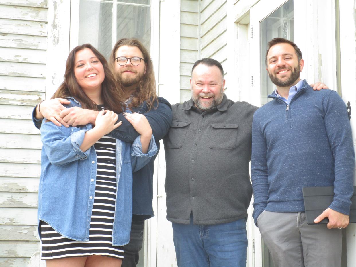 An episode of HGTV's "House Hunters" in Des Moines, featured local couple Justin Booth and Cooper Horning (left) pose in front of a possible new home with their agent Thomas Payne (right) and their dad (middle).