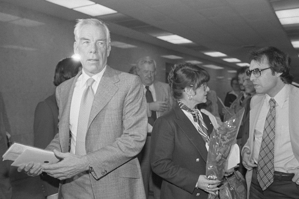 Michelle Triola Marvin, (R) holding a single rose is ignored by her former lover, Lee Marvin, as they return to Superior Court after a lunch break. The judge at the trial rejected an attempt by his mistress to seek $1 million in punitive damages for fraud